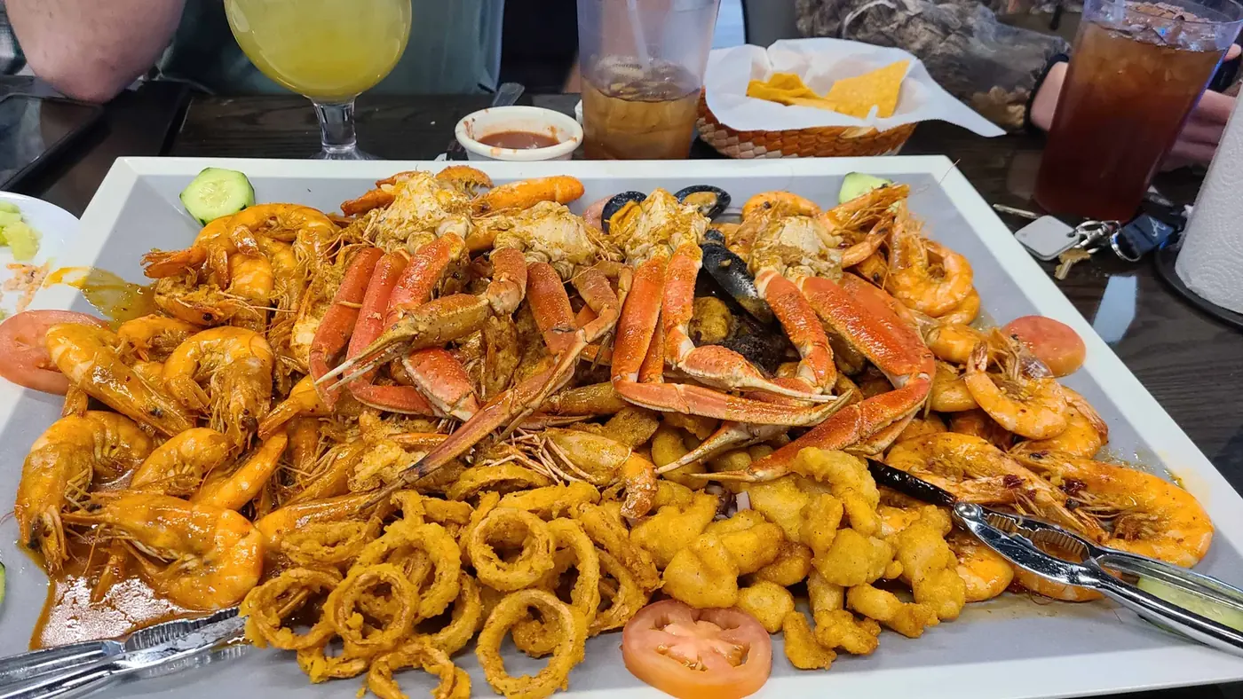 A mariscos platter with crab legs, shrimp and calamari