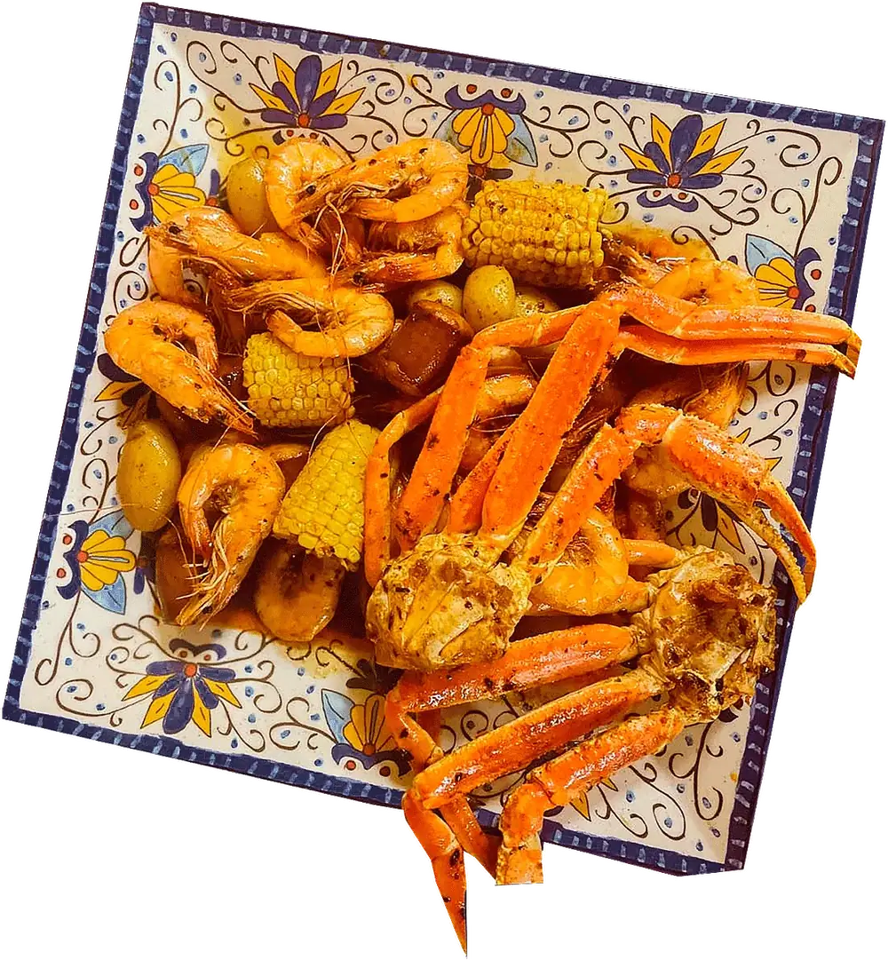 A seafood boil with crab legs, shrimp and corn on a talavera platter
